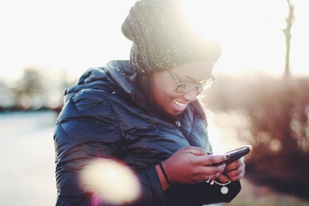 girl smiling at her smartphone