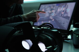 A VR headset in front of computer screen