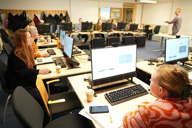 classroom with computers and people