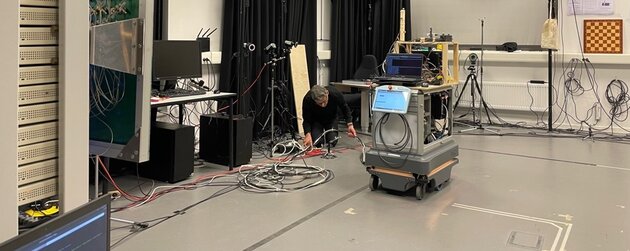 person working with lots of different cables to a mechanical device