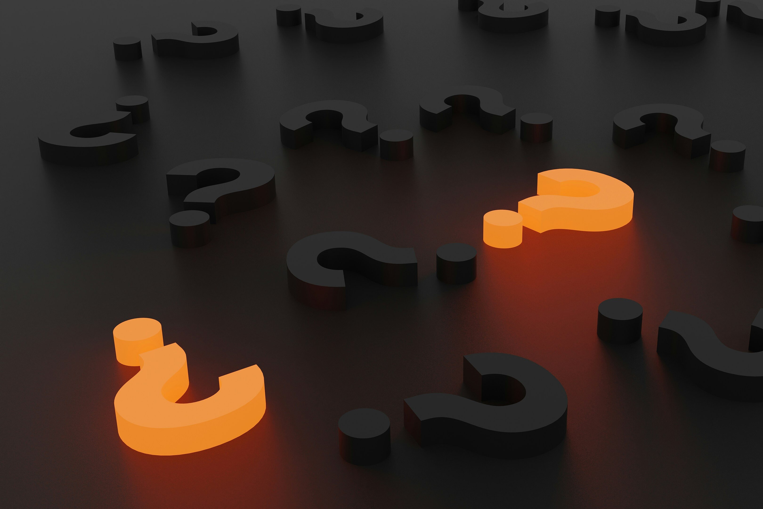 several questions marks on a table, two are highlighted 