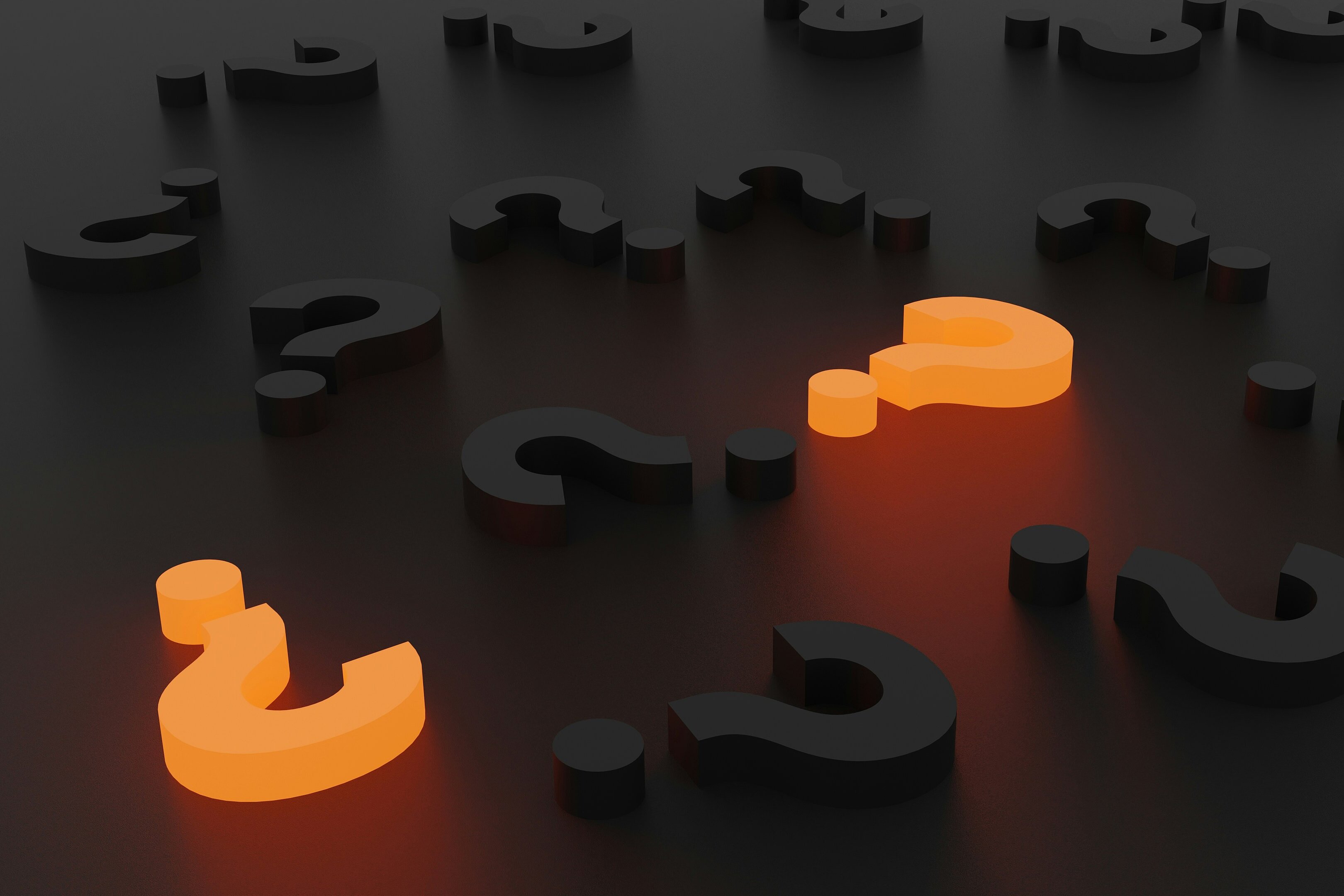 several questions marks on a table, two are highlighted