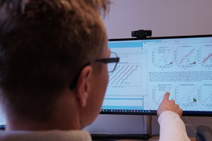 man pointing to computer screen with eye tracking data