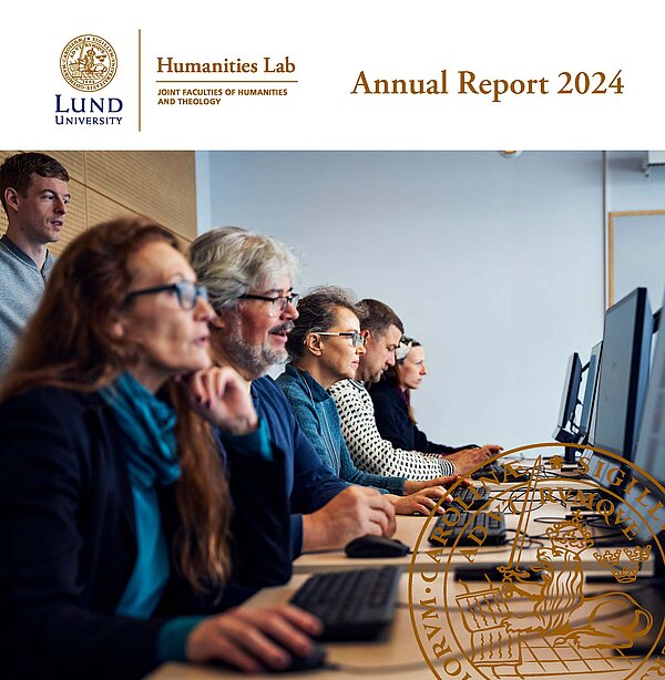 front page. Shows a row of people sitting in front of computers.