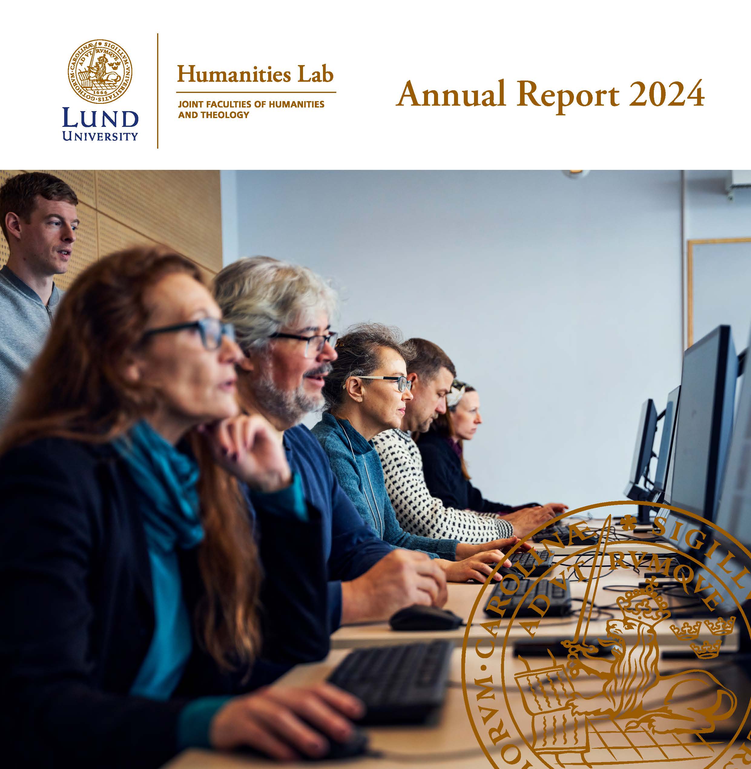 front page. Shows a row of people sitting in front of computers.